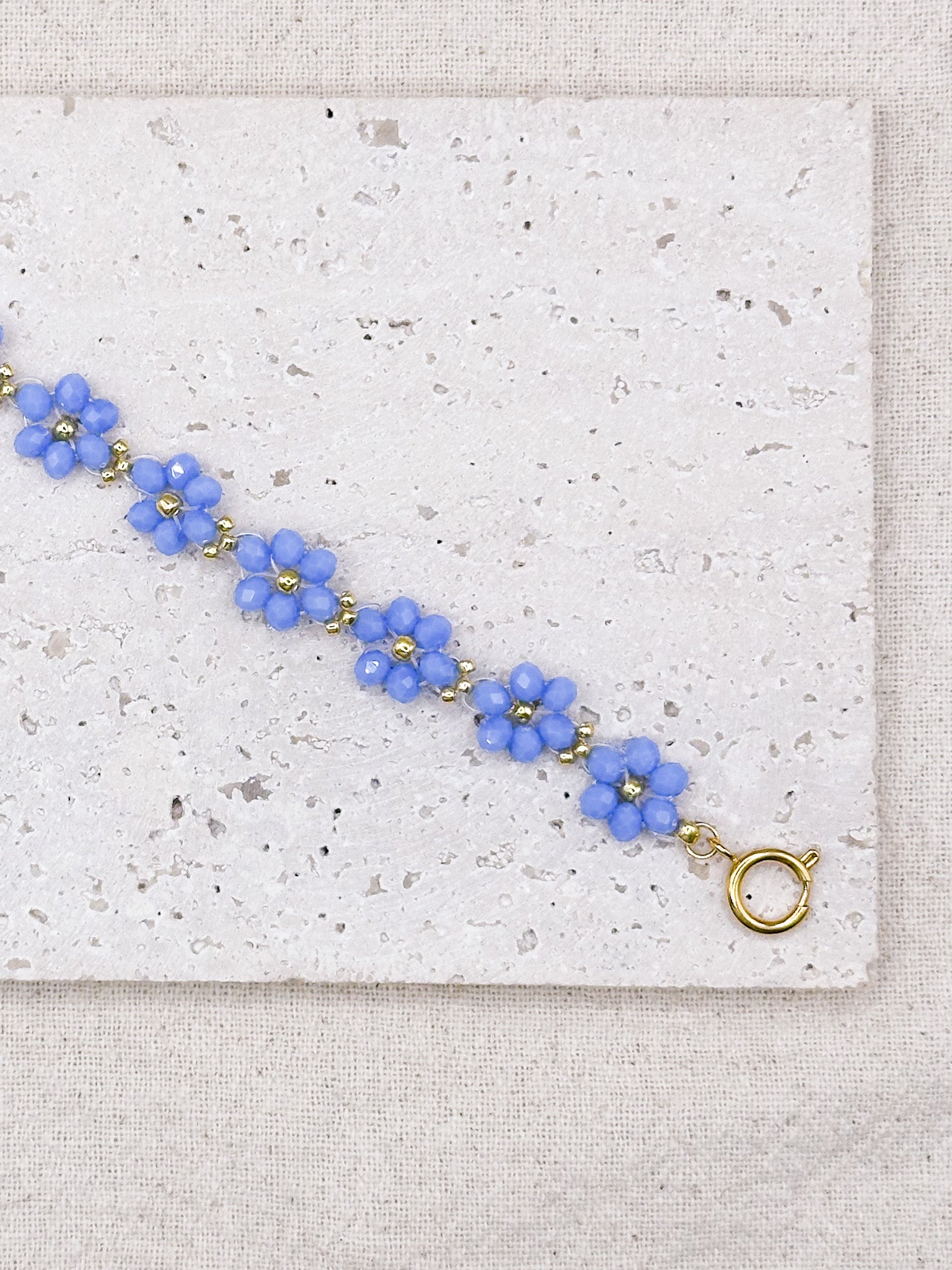 FLORA gold bracelet with blue flower-shaped beads